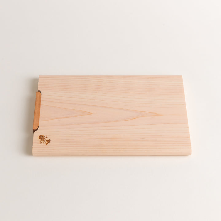 Small Hinoki wood cutting board with smooth grain, natural finish, corner handle, and engraved motif, crafted in Japan