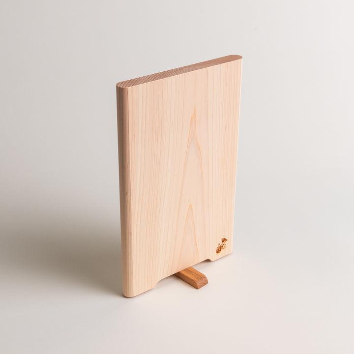 Small Hinoki wood cutting board with smooth grain, natural finish, corner handle, and engraved motif, crafted in Japan