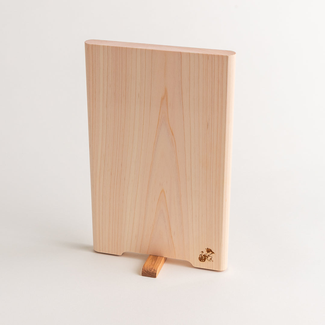 Small Hinoki wood cutting board with smooth grain, natural finish, corner handle, and engraved motif, crafted in Japan