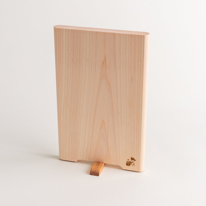 Small Hinoki wood cutting board with smooth grain, natural finish, corner handle, and engraved motif, crafted in Japan
