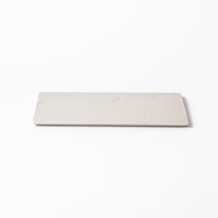 Textured white ceramic dinner plate with subtle ridged lines and matte-gloss contrast, perfect for refined Japanese dining and elegant plating.