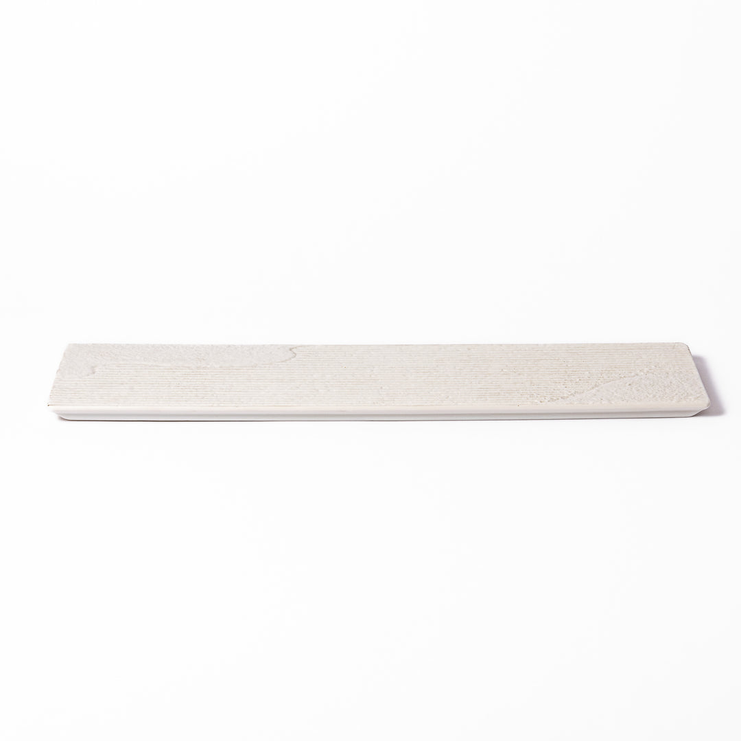 Rectangular white ceramic serving plate with fine ridged texture and soft matte-gloss contrast, ideal for modern Japanese table presentations.