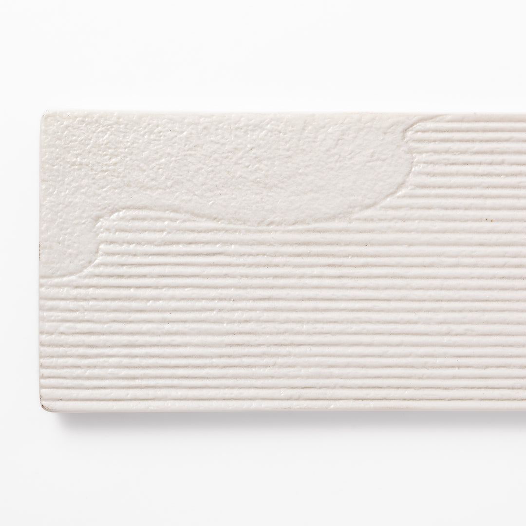 Rectangular white ceramic serving plate with fine ridged texture and soft matte-gloss contrast, ideal for modern Japanese table presentations.