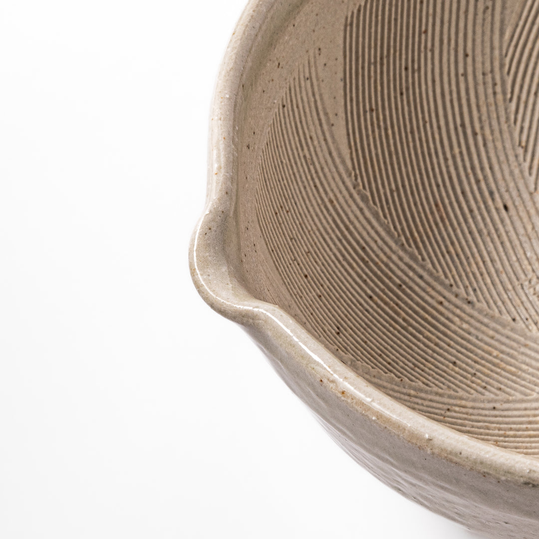 Soft sage-colored mortar with a speckled Hiwa glaze and grooved interior, perfect for grinding sesame or spices.
