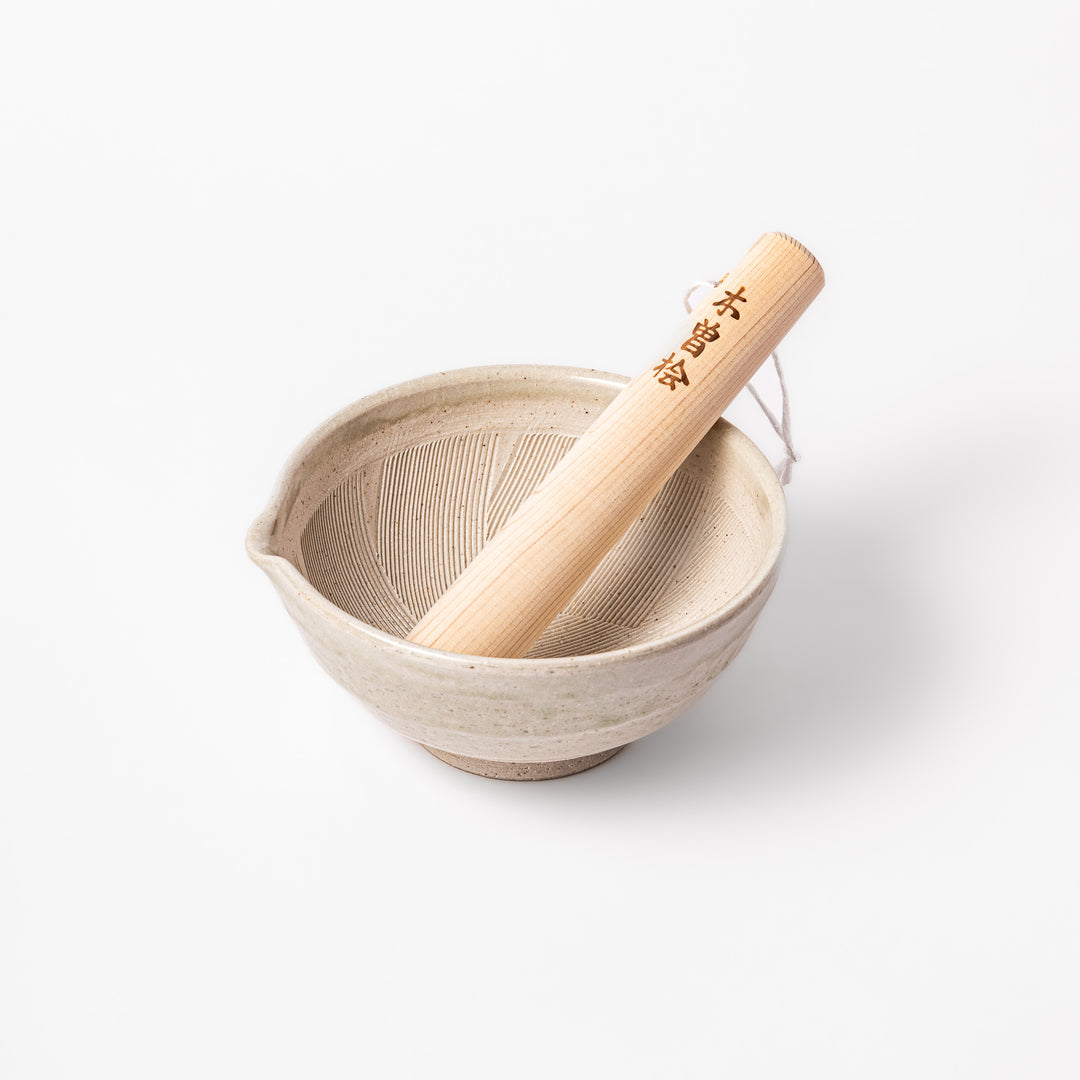 Soft sage Hiwa-glazed mortar with a smooth hinoki wood pestle, perfect for grinding sesame seeds and spices with ease.