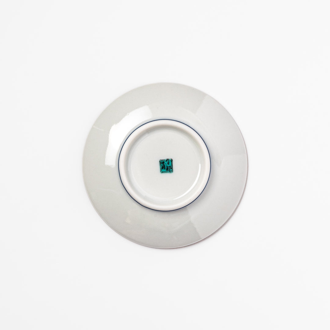 Round Japanese ceramic sauce dish with teal background, decorated with white and blue plum blossom motifs, perfect for serving condiments or small bites.