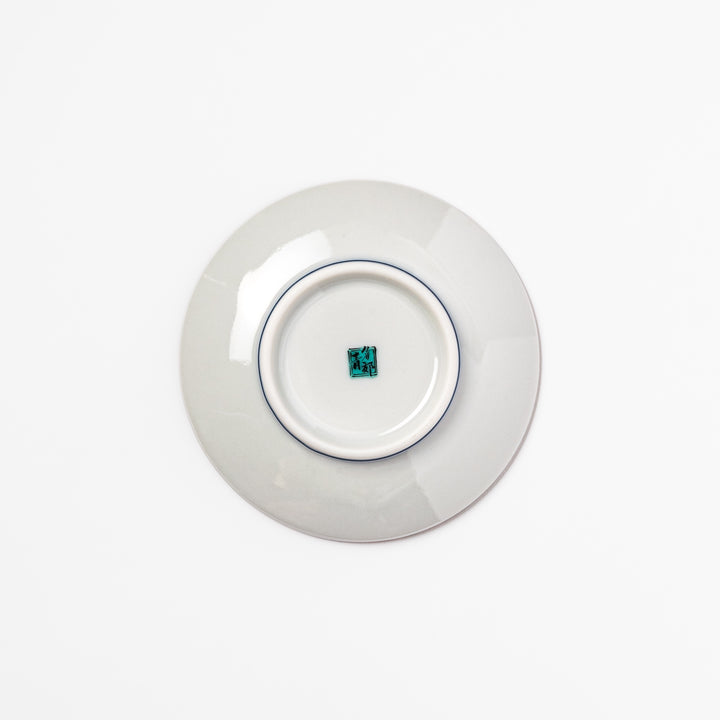 Round Japanese ceramic sauce dish with teal background, decorated with white and blue plum blossom motifs, perfect for serving condiments or small bites.