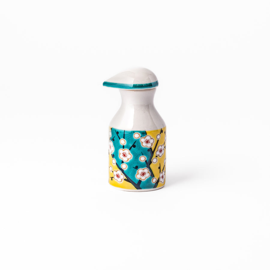 Japanese ceramic soy sauce dispenser with a teal lid and yellow body featuring white plum blossom motifs, handcrafted in Arita Japan.