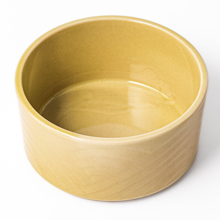 Yellow porcelain bowl with embossed Seigaiha wave pattern, showcasing a smooth matte glaze and simple, modern Japanese design.
