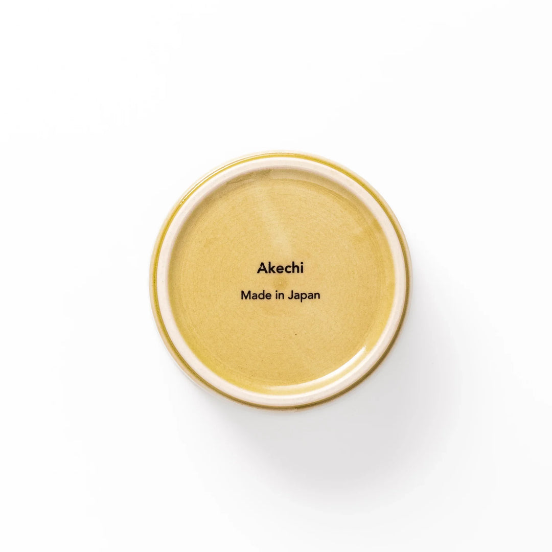 Yellow porcelain bowl with embossed Seigaiha wave pattern, showcasing a smooth matte glaze and simple, modern Japanese design.