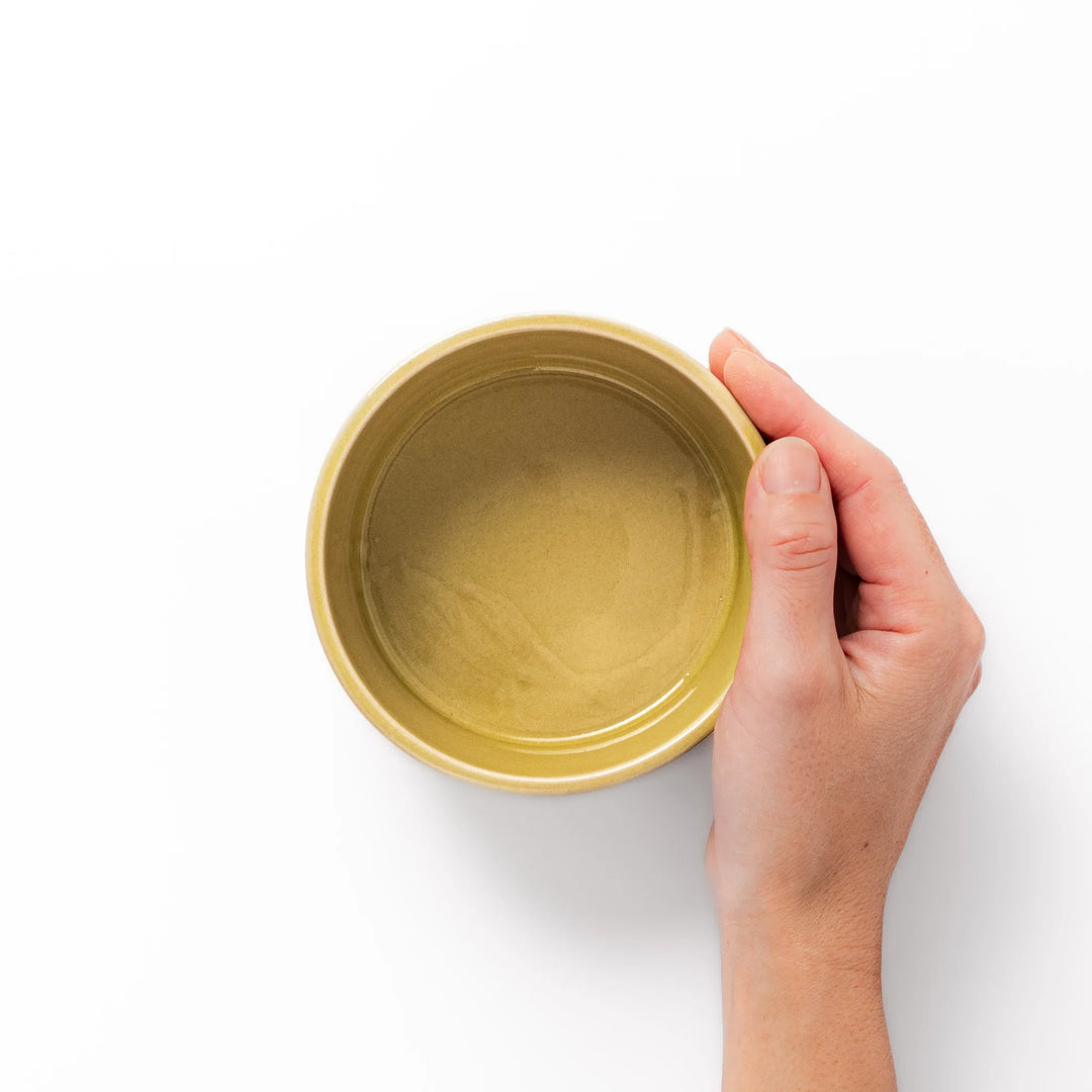 Yellow porcelain bowl with embossed Seigaiha wave pattern, showcasing a smooth matte glaze and simple, modern Japanese design.