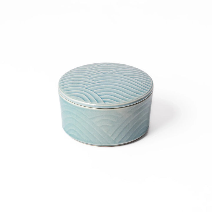 Light blue stackable porcelain bowl with matching lid, embossed with elegant Seigaiha wave pattern for a serene Japanese look.
