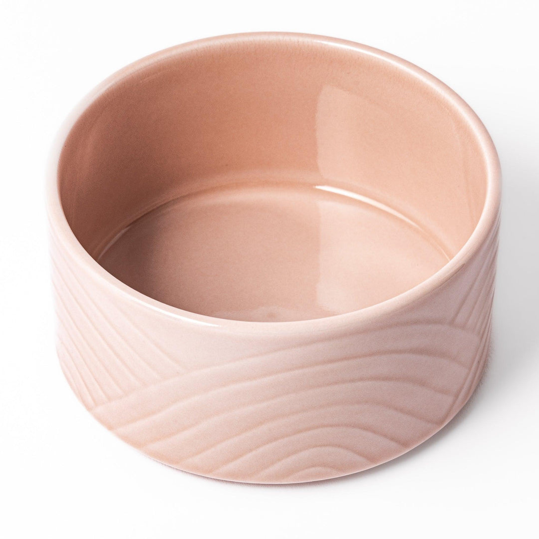Soft pink stackable porcelain bowl with embossed Seigaiha wave pattern, blending modern simplicity with gentle Japanese warmth.