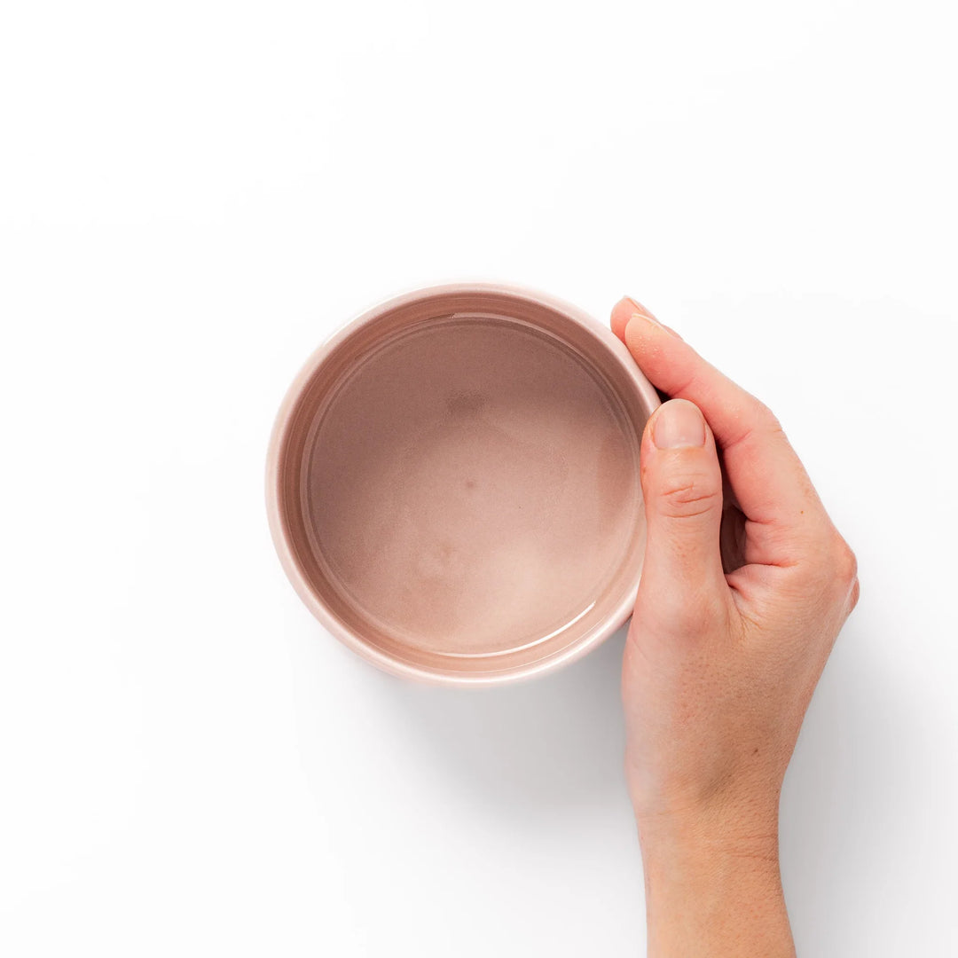 Soft pink stackable porcelain bowl with embossed Seigaiha wave pattern, blending modern simplicity with gentle Japanese warmth.