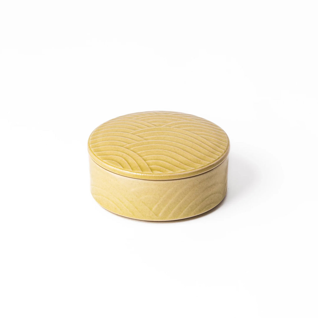 Small yellow porcelain bowl with matching lid, embossed with a Seigaiha wave pattern for a calm, modern Japanese look.