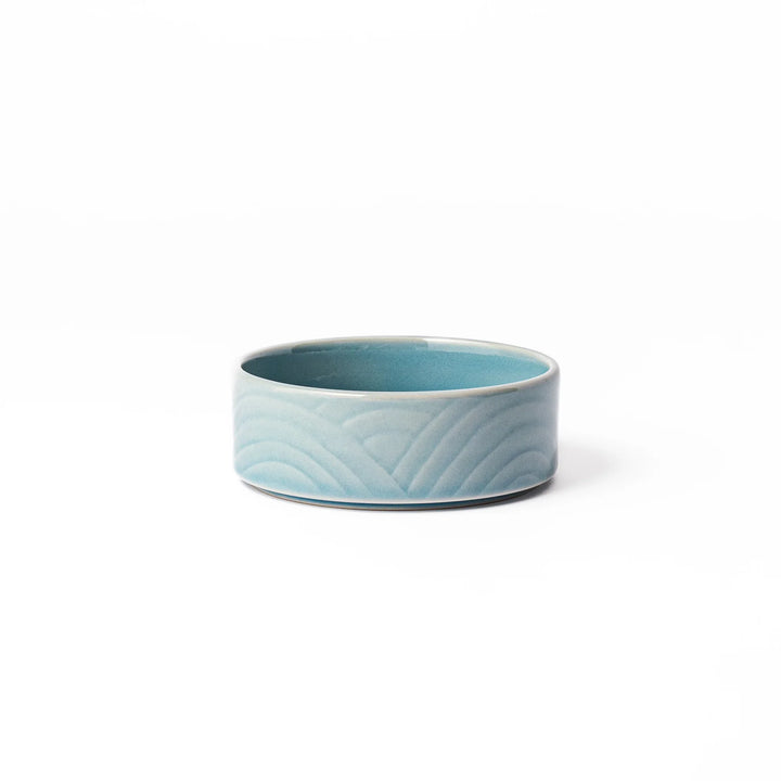 Light blue porcelain bowl embossed with a gentle Seigaiha wave pattern, showcasing a serene and minimalist Japanese design.