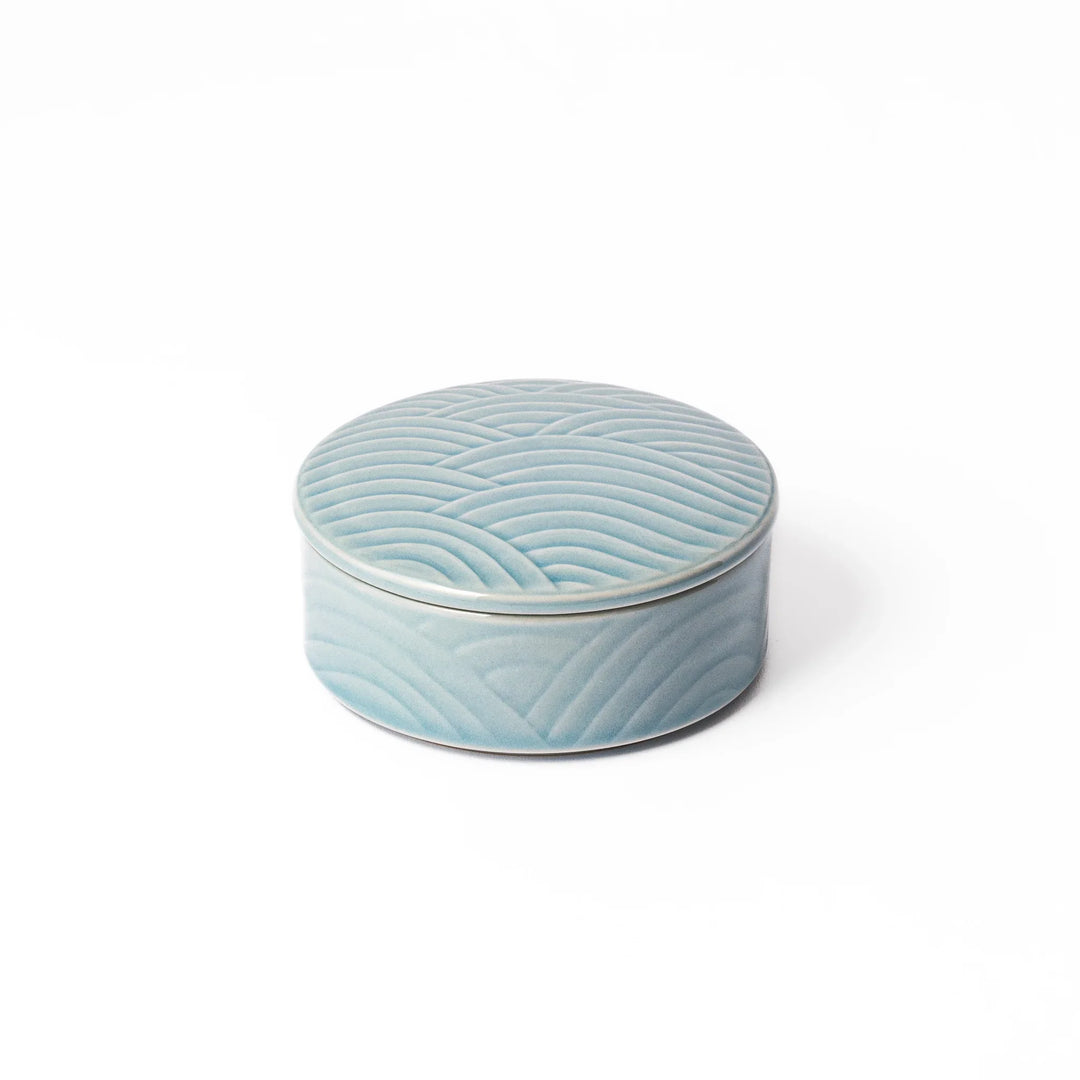 Light blue porcelain bowl with matching lid, featuring embossed Seigaiha wave patterns for an elegant, stackable Japanese design.