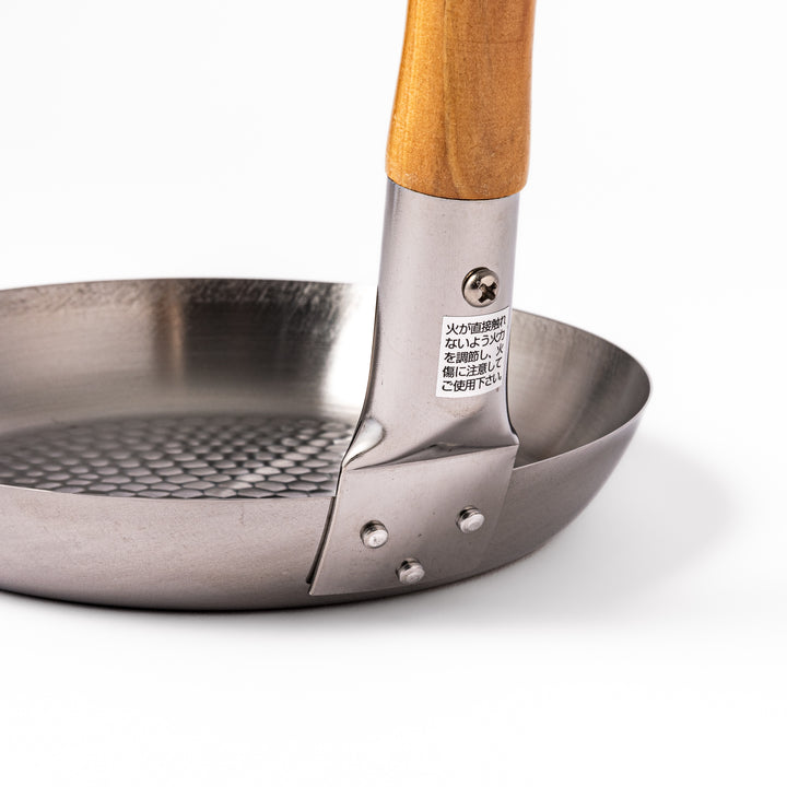 Japanese stainless steel donburi pot with a wooden handle and hammered base, designed for evenly heating and serving rice bowls, simmered dishes, and sauces.