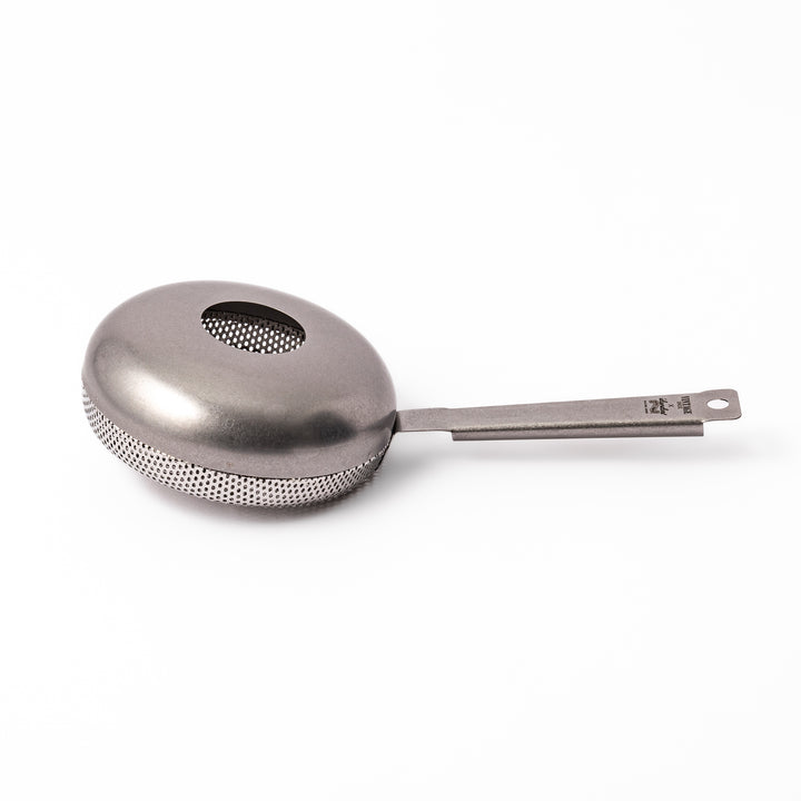 Japanese stainless steel hand coffee roaster with perforated drum and long handle, designed for evenly roasting coffee beans over open flame at home.