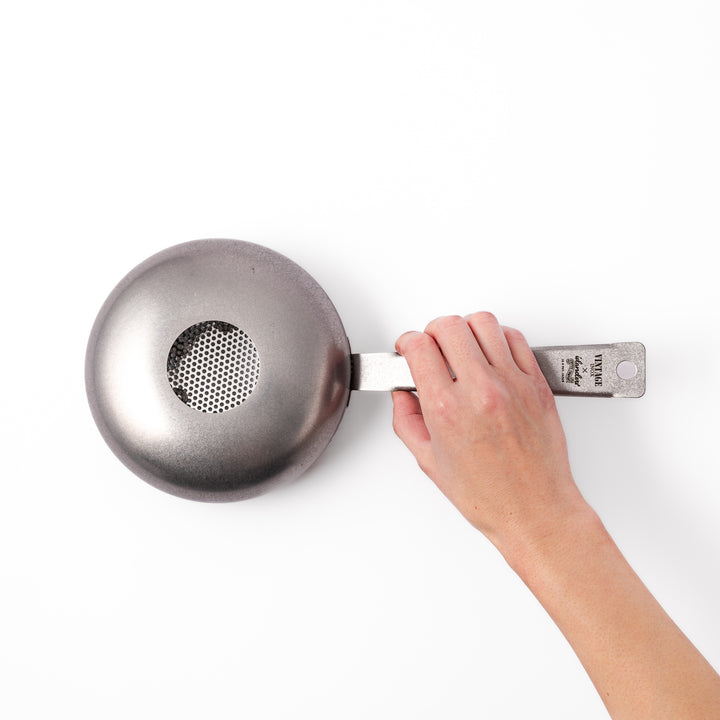 Japanese stainless steel hand coffee roaster with perforated drum and long handle, designed for evenly roasting coffee beans over open flame at home.