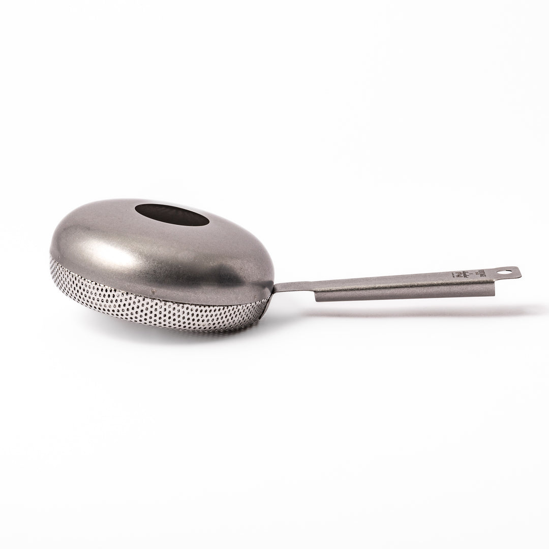 Japanese stainless steel hand coffee roaster with perforated drum and long handle, designed for evenly roasting coffee beans over open flame at home.