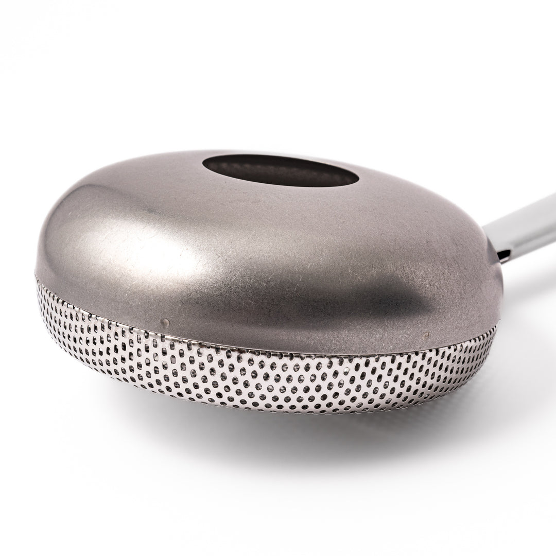 Japanese stainless steel hand coffee roaster with perforated drum and long handle, designed for evenly roasting coffee beans over open flame at home.