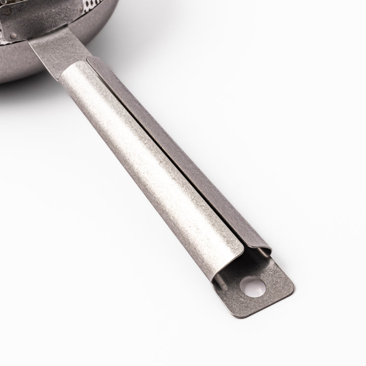 Japanese stainless steel hand coffee roaster with perforated drum and long handle, designed for evenly roasting coffee beans over open flame at home.