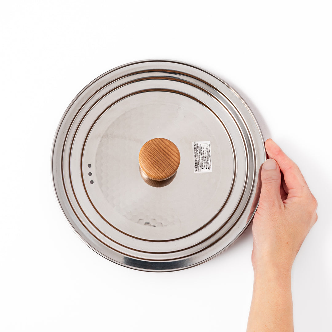 Stainless steel lid with a natural wooden knob designed for Yukihira pots, combining modern simplicity and traditional Japanese craftsmanship for everyday cooking use.