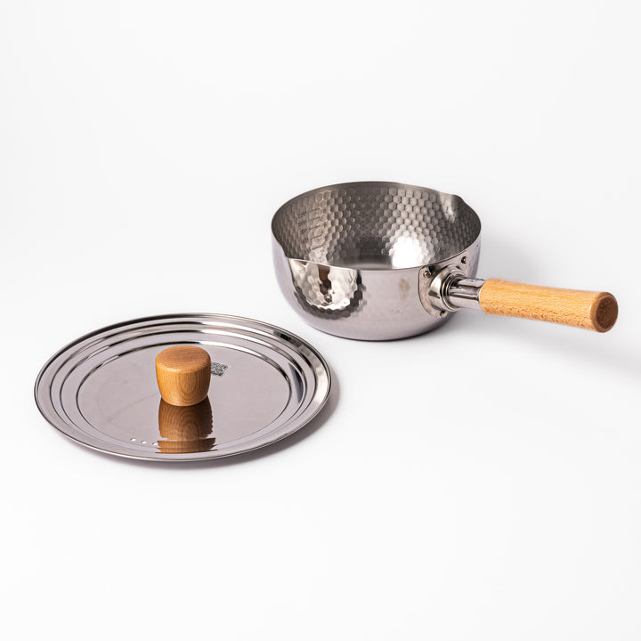Japanese stainless steel Yukihira pot with matching lid featuring a wooden knob and hammered finish, crafted for everyday soups, sauces, and traditional home cooking.