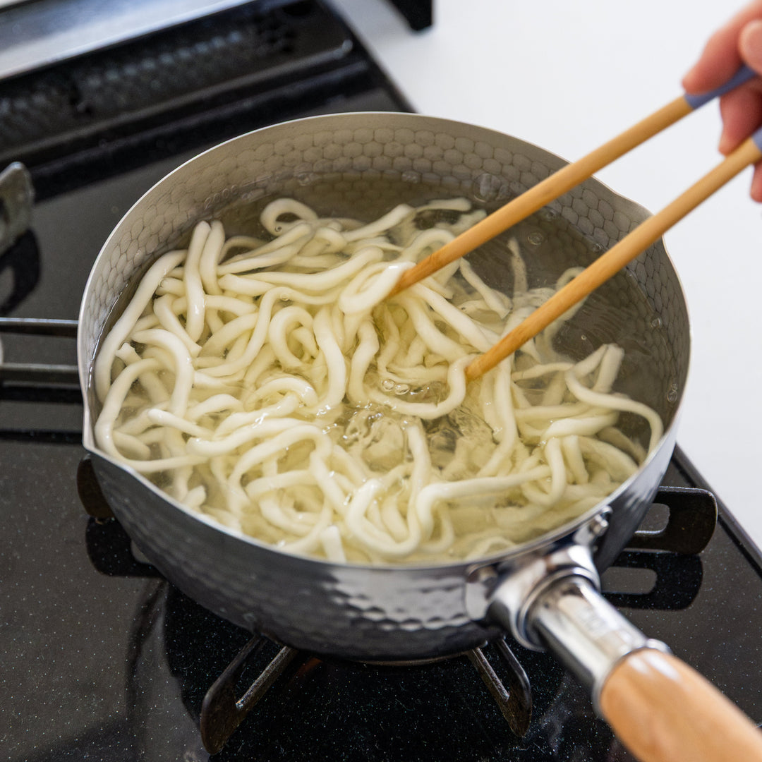 Stainless Steel Yukihira Pot boiling udon noodles on stovetop