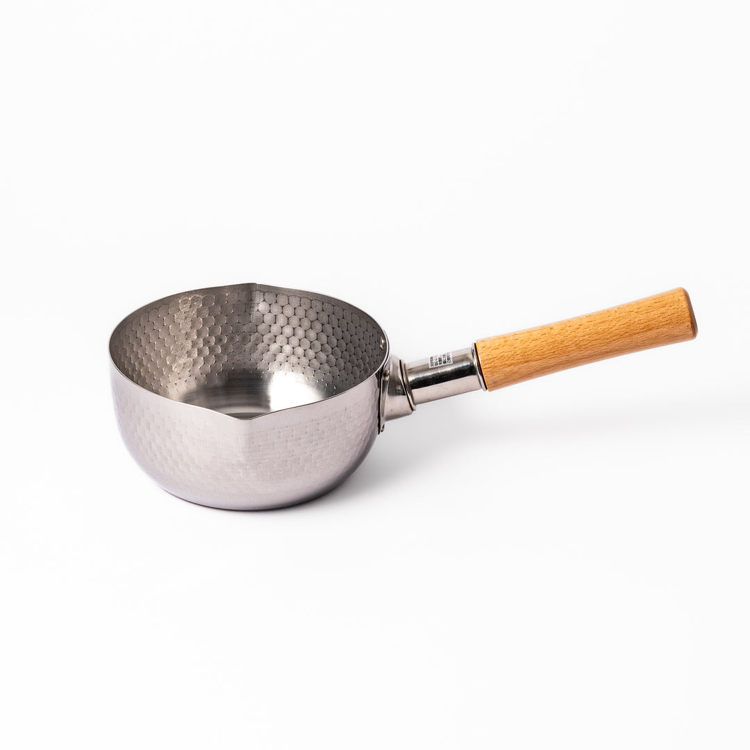 Japanese stainless steel Yukihira pot with a wooden handle and hammered finish, featuring twin pour spouts for easy cooking, simmering, and sauce preparation.