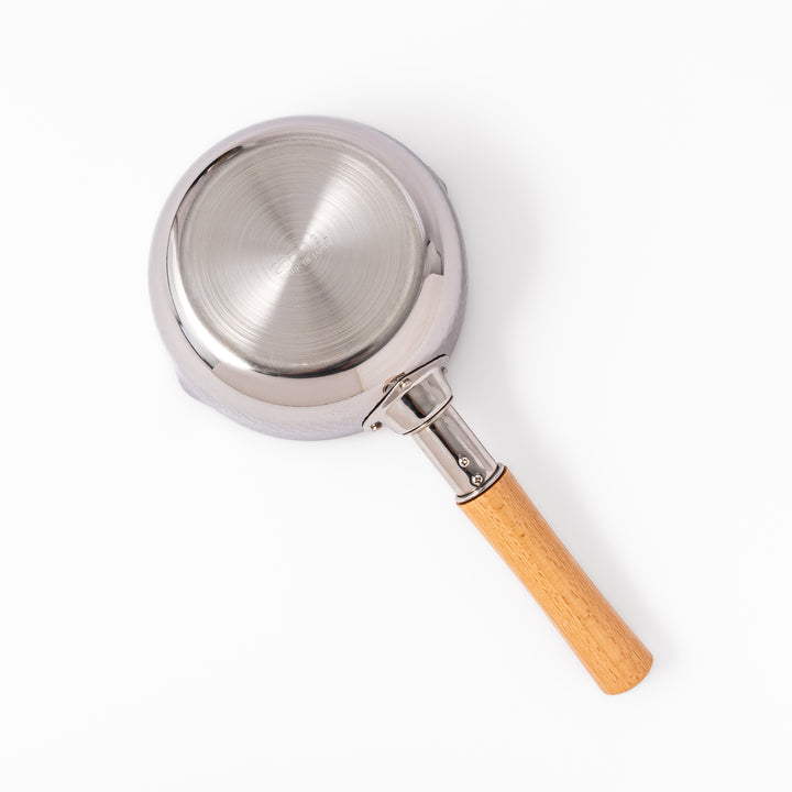 Japanese stainless steel Yukihira pot with a wooden handle and hammered finish, featuring twin pour spouts for easy cooking, simmering, and sauce preparation.