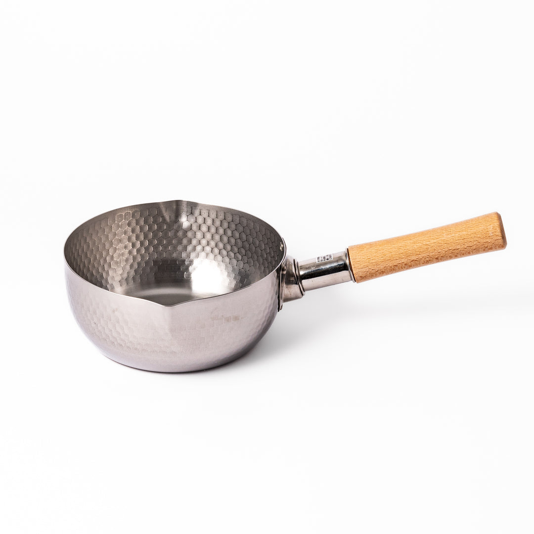 Stainless steel Yukihira pot with a wooden handle featuring a hammered texture and dual pour spouts, ideal for making soups, sauces, and everyday Japanese cooking.