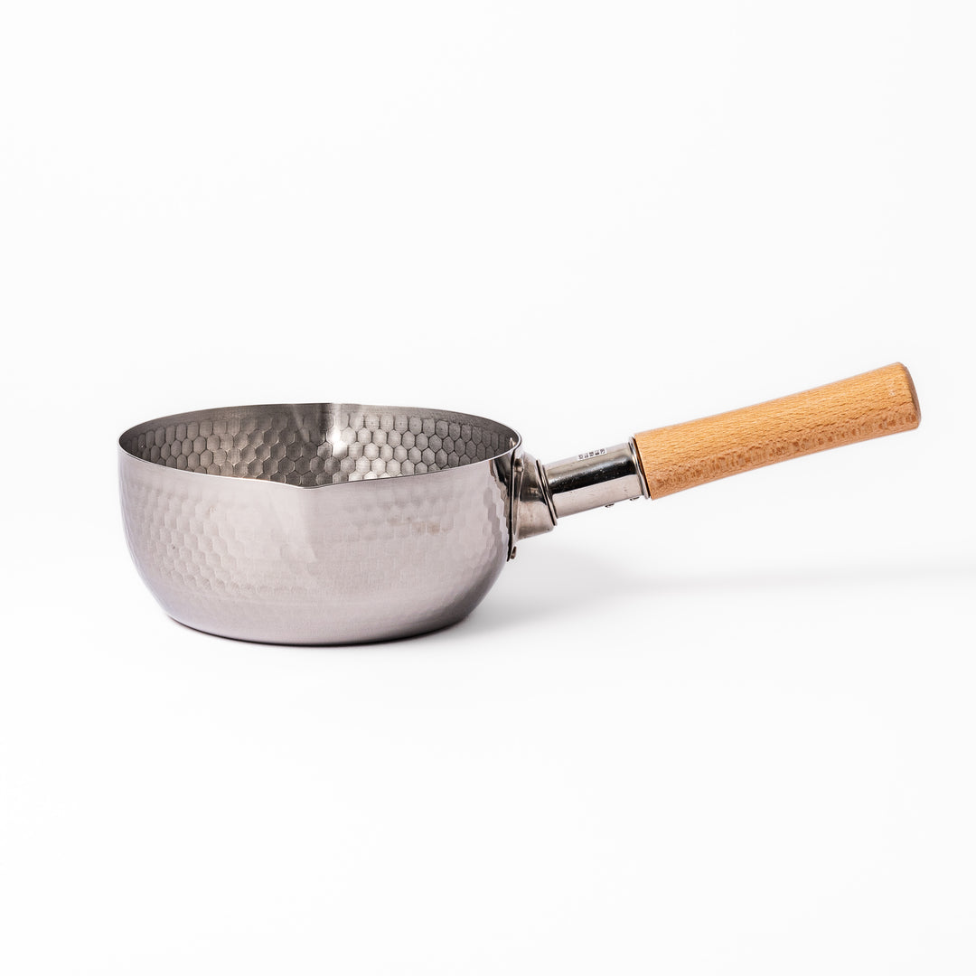 Stainless steel Yukihira pot with a wooden handle featuring a hammered texture and dual pour spouts, ideal for making soups, sauces, and everyday Japanese cooking.