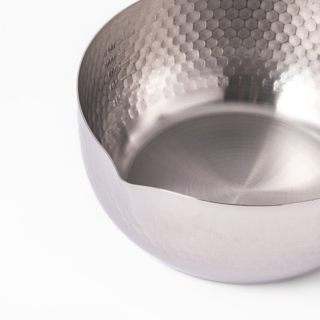 Stainless steel Yukihira pot with a wooden handle featuring a hammered texture and dual pour spouts, ideal for making soups, sauces, and everyday Japanese cooking.