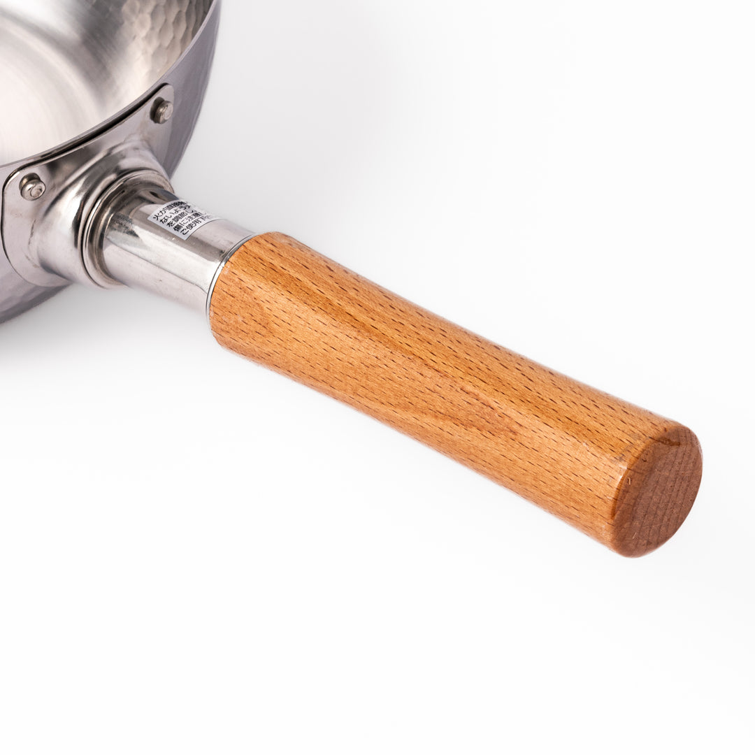Japanese stainless steel Yukihira pot with a hammered finish and wooden handle, crafted for making soups, sauces, and simmered dishes with even heat distribution.