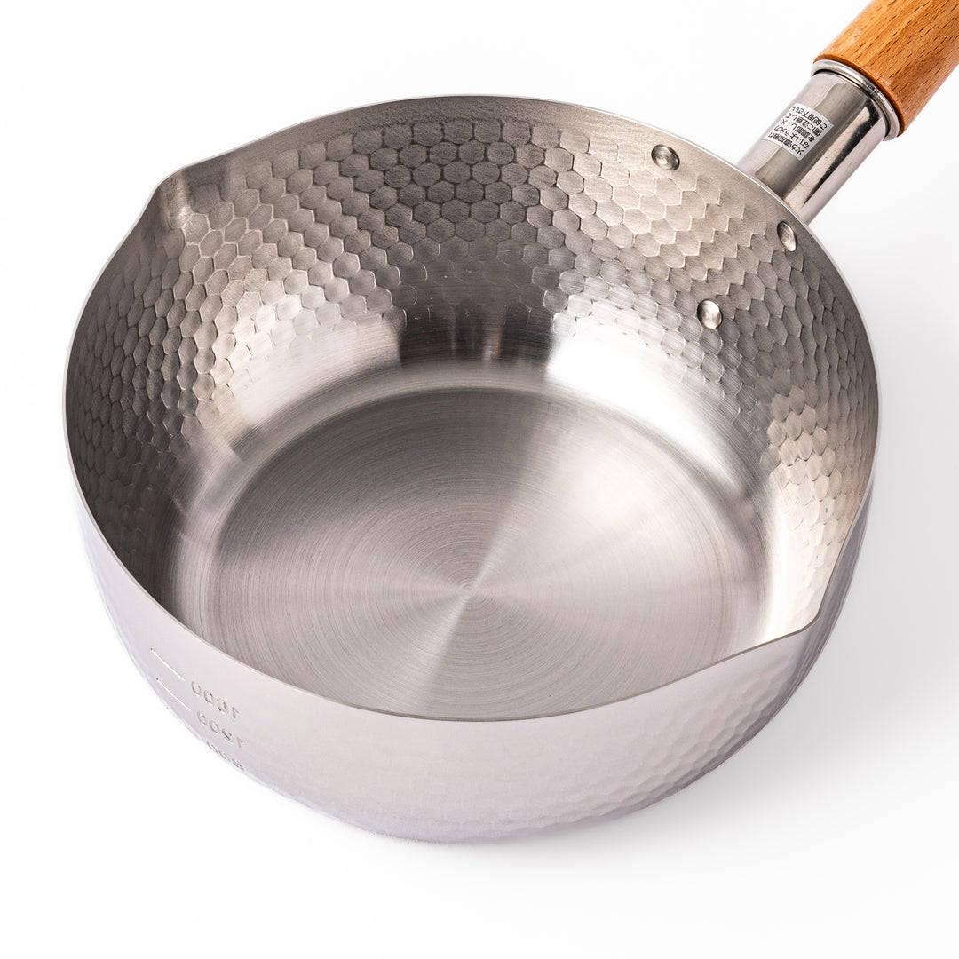Japanese stainless steel Yukihira pot with a hammered finish and wooden handle, crafted for making soups, sauces, and simmered dishes with even heat distribution.