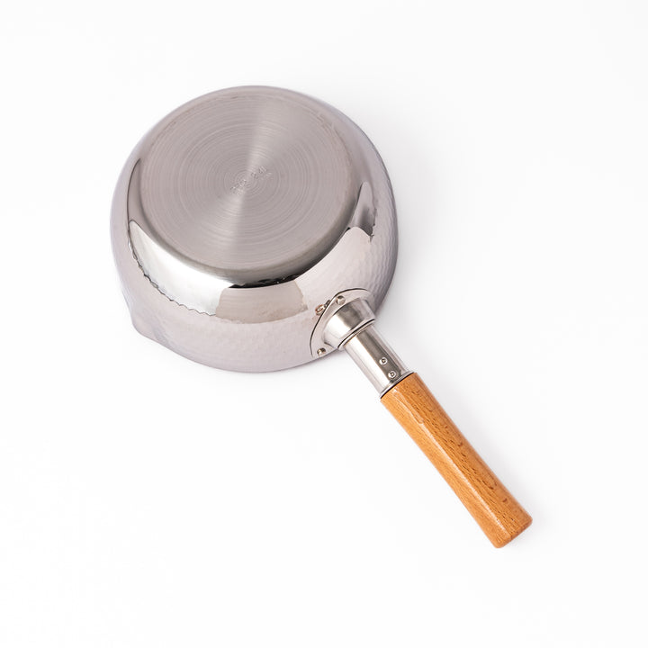 Japanese stainless steel Yukihira pot with a hammered finish and wooden handle, crafted for making soups, sauces, and simmered dishes with even heat distribution.