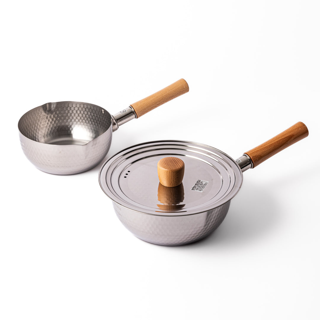 Japanese stainless steel Yukihira pots with wooden handles and hammered finish, one with matching lid, designed for everyday soups, simmered dishes, and versatile cooking.