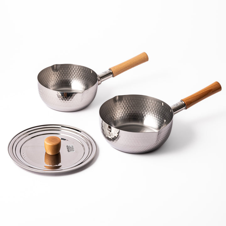 Set of Japanese stainless steel Yukihira pots with wooden handles and matching lid, featuring hammered texture and dual spouts for versatile everyday cooking.