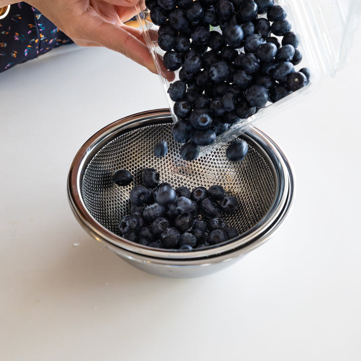 Extra small Japanese stainless steel mesh strainer and bowl, perfect for holding and washing fresh blueberries