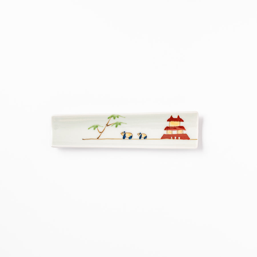 Japanese porcelain chopstick rest with whimsical China design featuring red pagoda, pandas, bamboo, and green tree accents