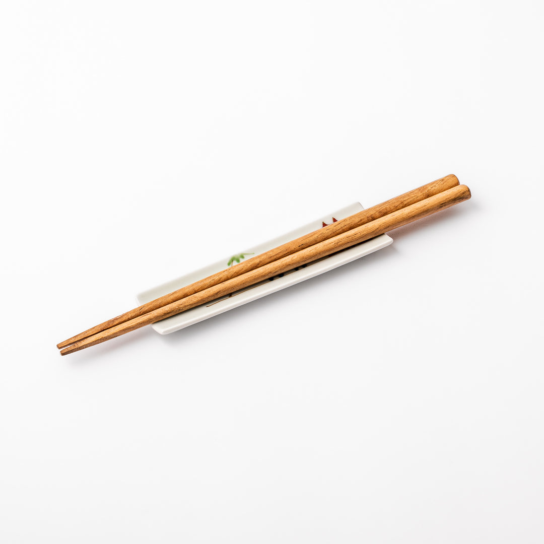 Japanese porcelain chopstick rest with whimsical China design featuring red pagoda, pandas, bamboo, and green tree accents