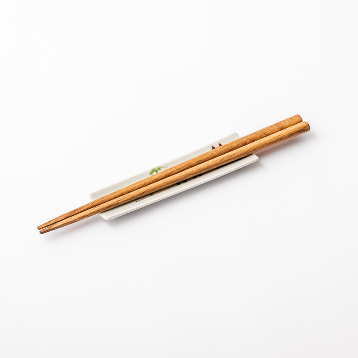 Japanese porcelain chopstick rest with whimsical China design featuring red pagoda, pandas, bamboo, and green tree accents