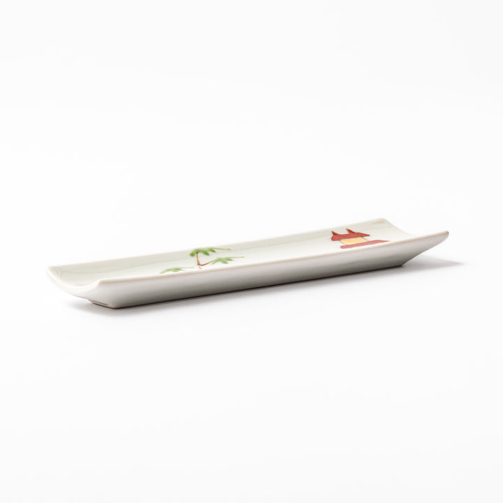 Japanese porcelain chopstick rest with whimsical China design featuring red pagoda, pandas, bamboo, and green tree accents