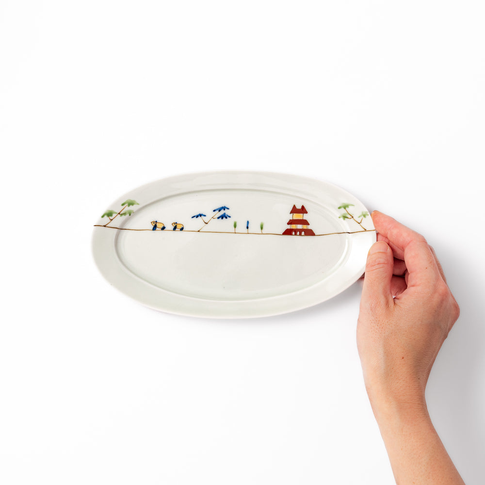 Japanese porcelain oval plate with whimsical China design featuring pandas, bamboo trees, and a traditional red pagoda