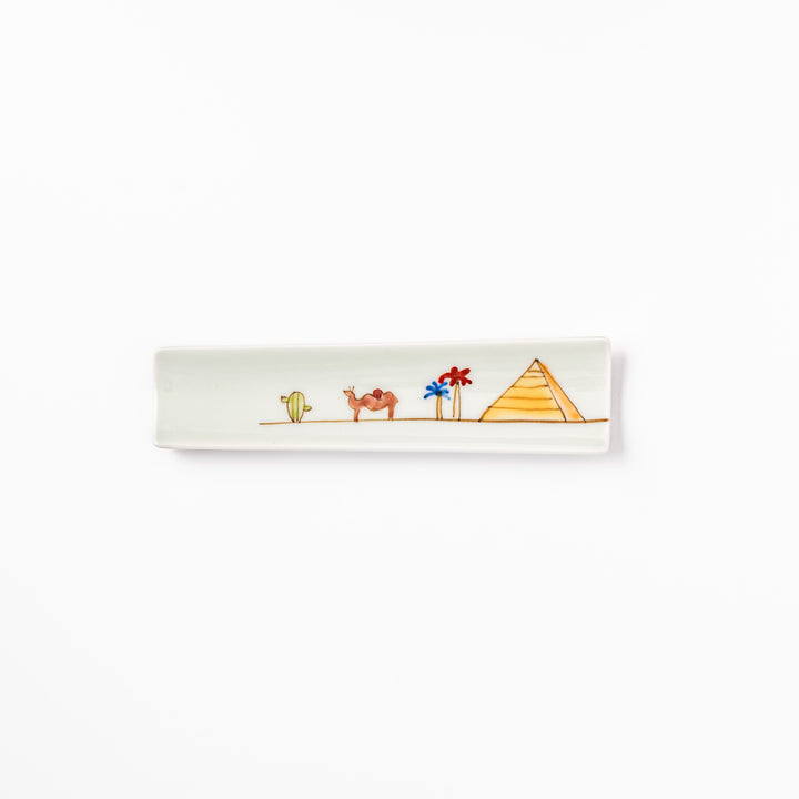 Japanese porcelain chopstick rest with whimsical Egypt design featuring pyramid, camel, cactus, and colorful palm trees
