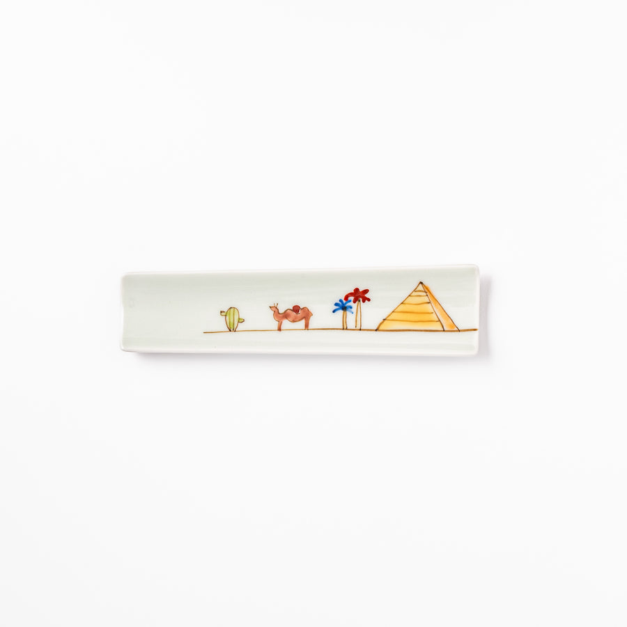 Japanese porcelain chopstick rest with whimsical Egypt design featuring pyramid, camel, cactus, and colorful palm trees