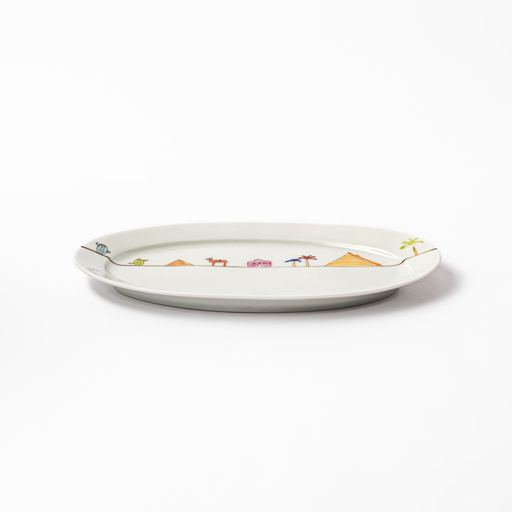 Japanese porcelain oval plate with whimsical Egypt design featuring pyramids, camel, palm trees, and desert-inspired details