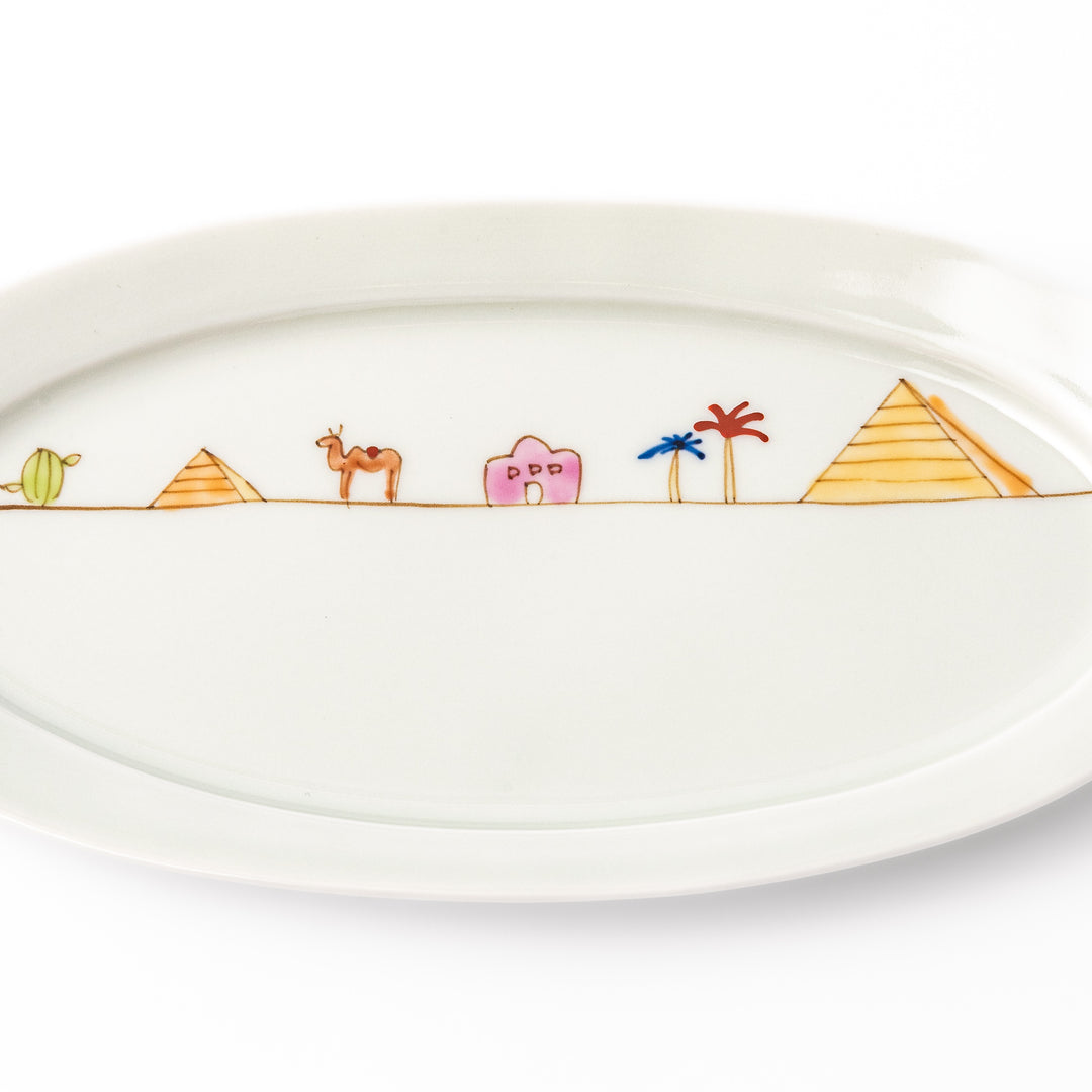 Japanese porcelain oval plate with whimsical Egypt design featuring pyramids, camel, palm trees, and desert-inspired details
